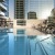 Rooftop pool with in-water loungers and skyline views at a luxury high-rise in Dallas