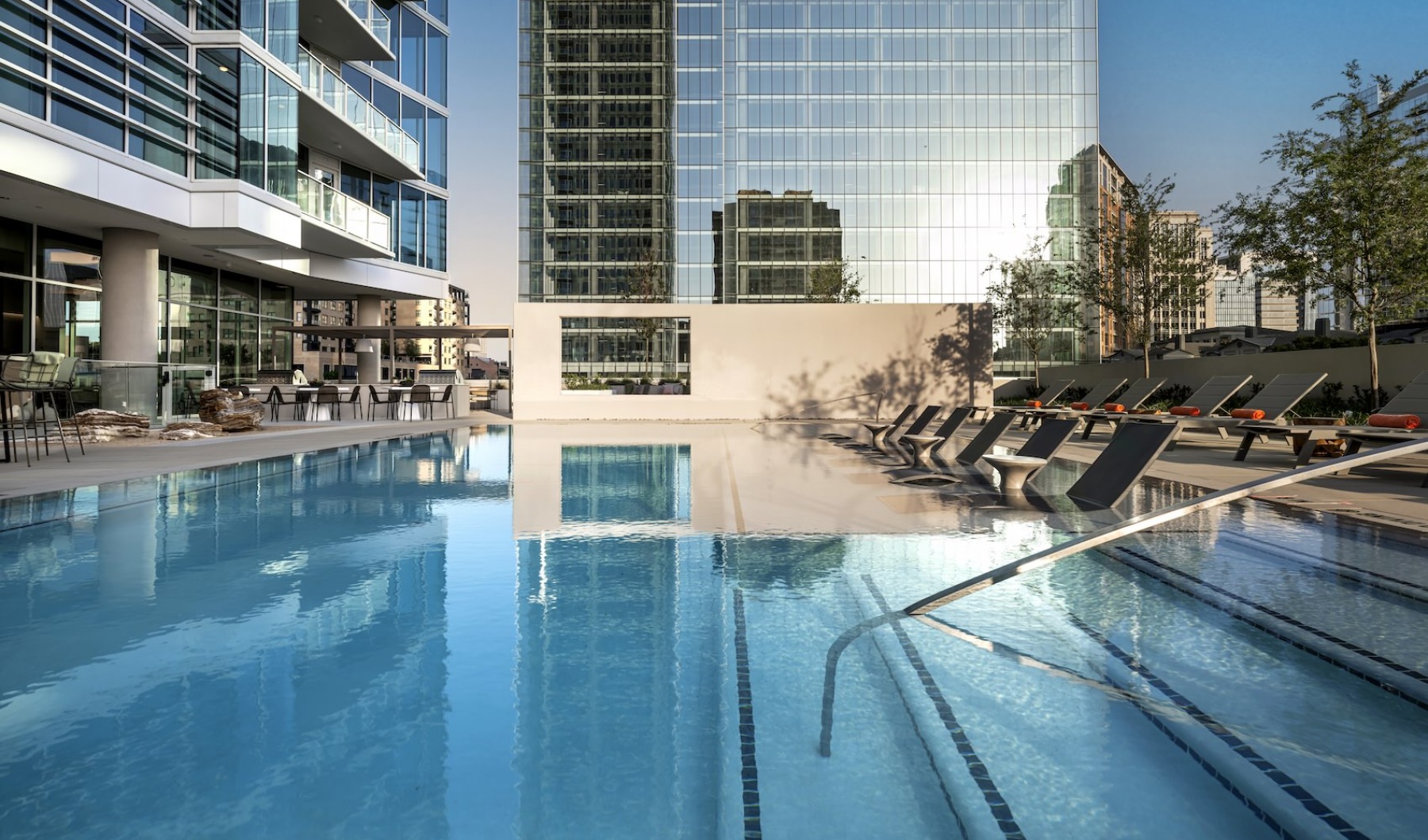 Elevated Pool Deck at 2811 Maple with City Views Rooftop pool with in-water loungers and skyline views at a luxury high-rise in Dallas
