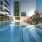 Rooftop pool with in-water loungers and skyline views at a luxury high-rise in Dallas