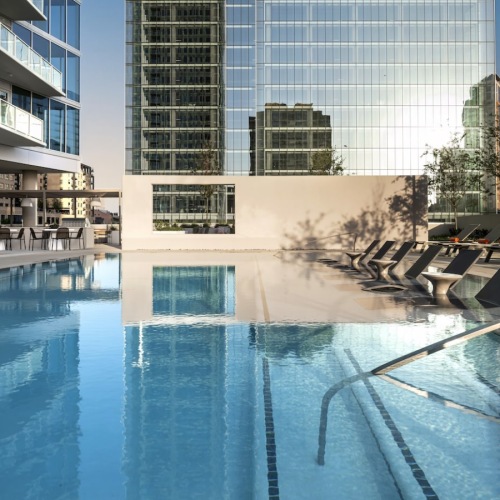 Elevated Pool Deck at 2811 Maple with City Views Rooftop pool with in-water loungers and skyline views at a luxury high-rise in Dallas