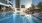 Rooftop pool with in-water loungers and skyline views at a luxury high-rise in Dallas