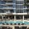 Resort-style pool surrounded by lounge seating and modern architecture at 2811 Maple in Dallas