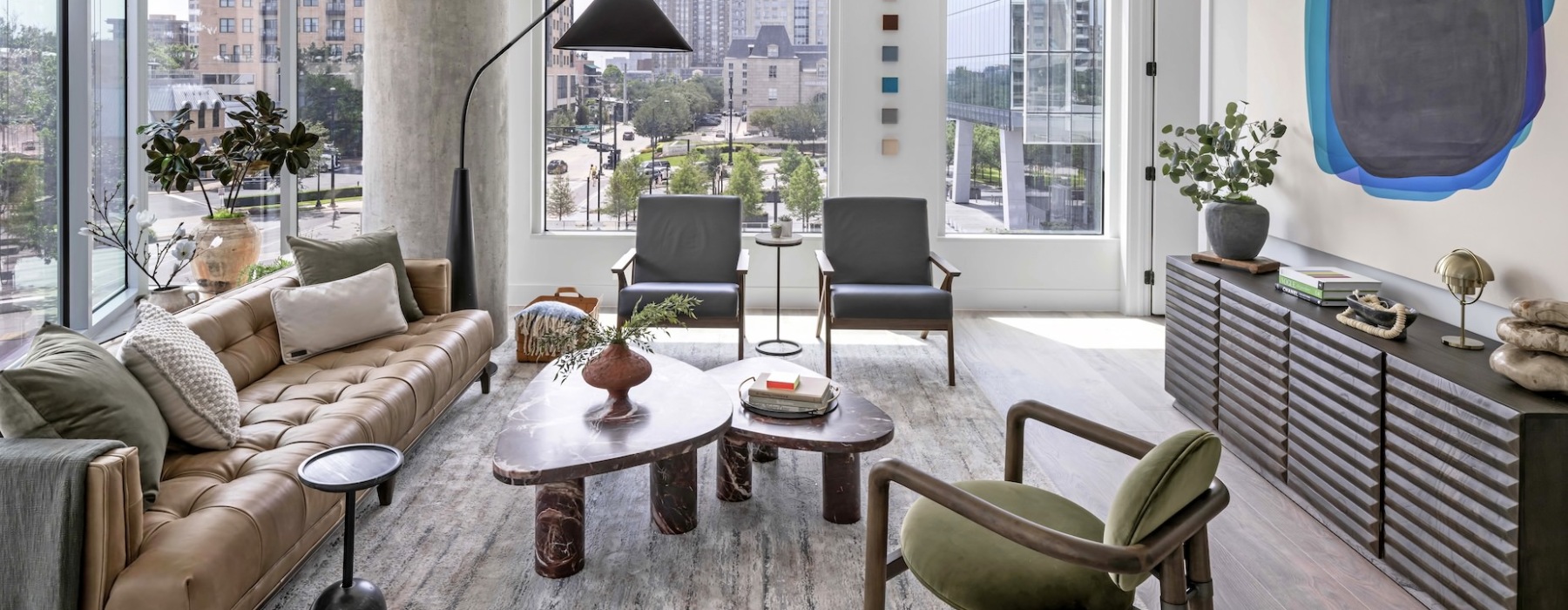a living room with a couch, tables and chairs