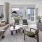 Model apartment living room with designer furnishings, floor-to-ceiling windows, and city views at 2811 Maple
