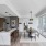 Model apartment kitchen and dining area with waterfall island, modern finishes, and floor-to-ceiling windows at 2811 Maple