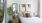 Bright bedroom with modern furnishings, abstract artwork, and large windows at 2811 Maple