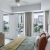 Model bedroom with upholstered headboard, stylish decor, and views of Uptown Dallas