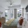 Model bedroom with upholstered headboard, stylish decor, and views of Uptown Dallas