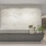 Modern leasing desk with sculpted botanical wall detail and minimalist design at 2811 Maple in Dallas
