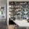 Designer bookshelf filled with curated books and sculptures in a modern resident lounge at 2811 Maple